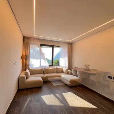 AI generated video: Cinematic slow dolly shot gliding through this empty modern apartment. 
The space has large grey cer...