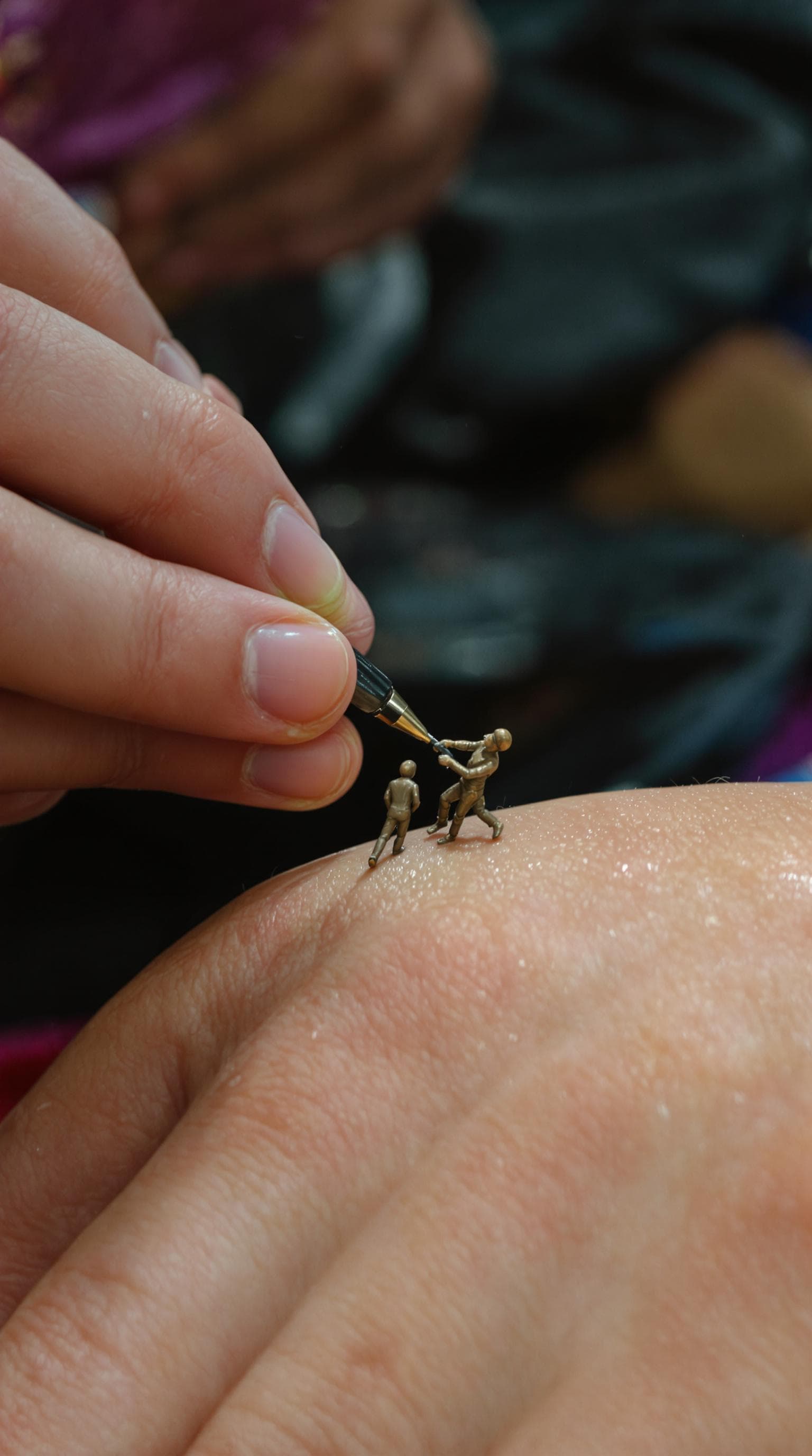 AI generated: Really small miniature figure people making tattoo on a girl's hand