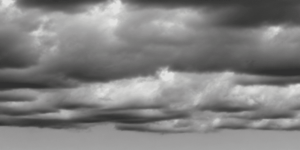 AI generated: full sky of flat simple texture cartoonish multiple semi-real flat stormy clouds in greyscale