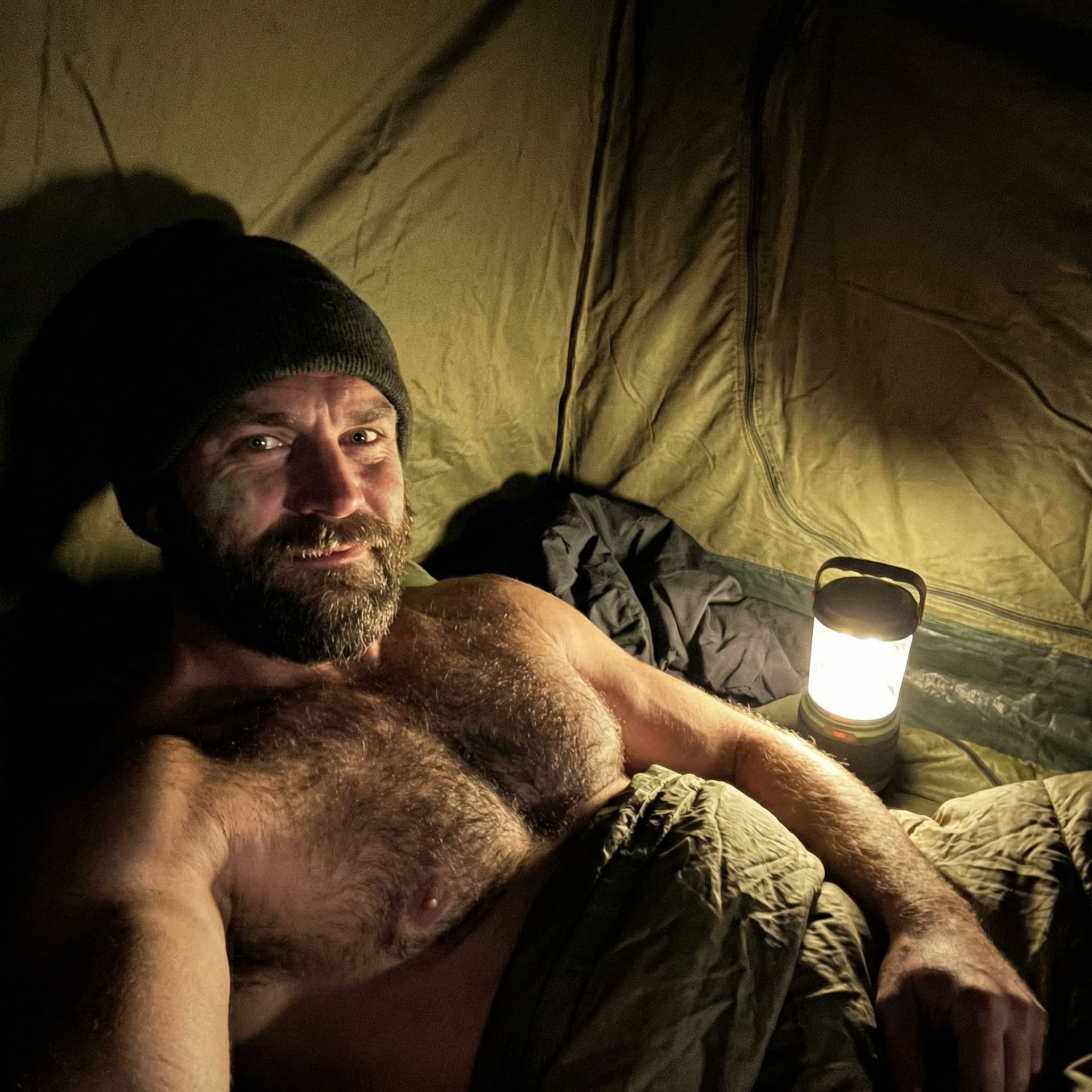 AI generated: Raw realistic low-light selfie photograph of a rugged, handsome man in his late 20s to early 30s ins...