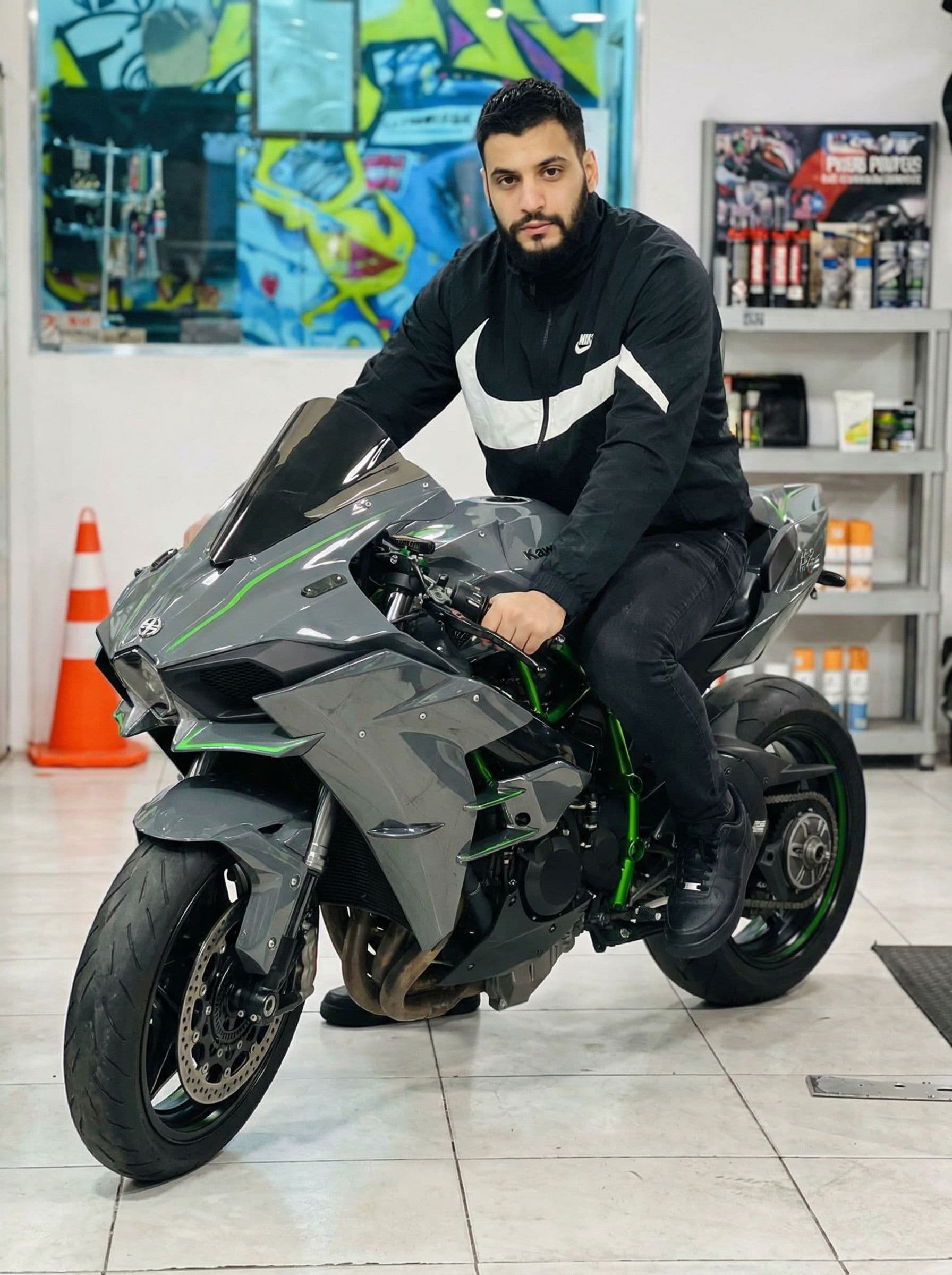 AI generated: Adding me on this bike wearing a big Nike on black jacket ( Nike jacket ), black jeans and full blac...