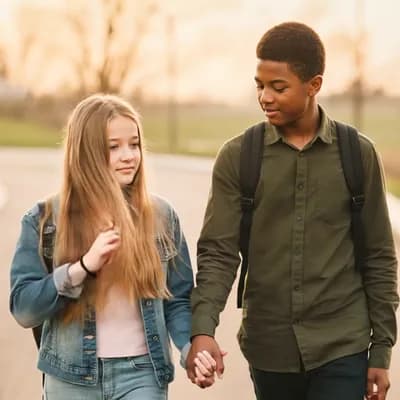 AI generated video: the camera moves back to show a full body View as the couple slowly approaches