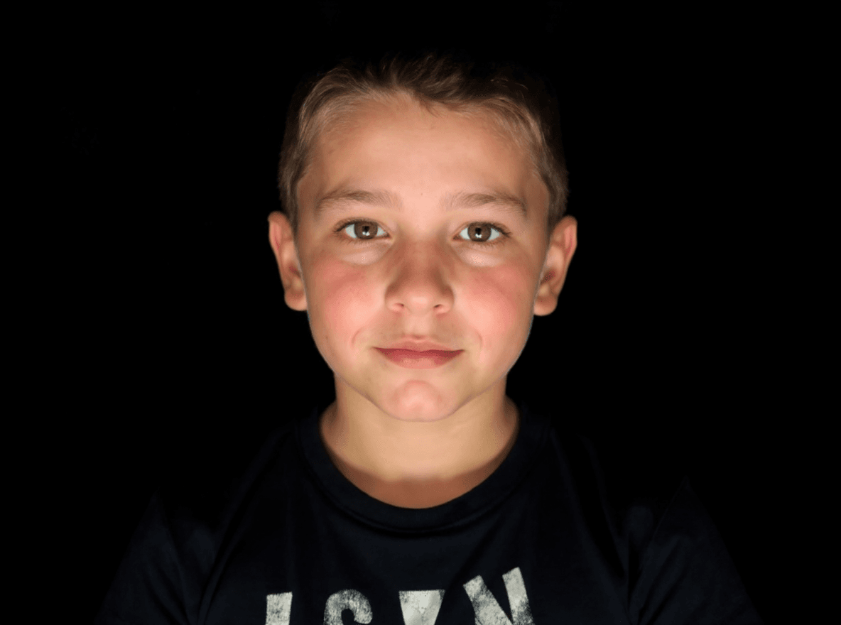AI generated: editorial photography, front shot, upper-body, 8 years old boy model, gaze, capturing a bright light...