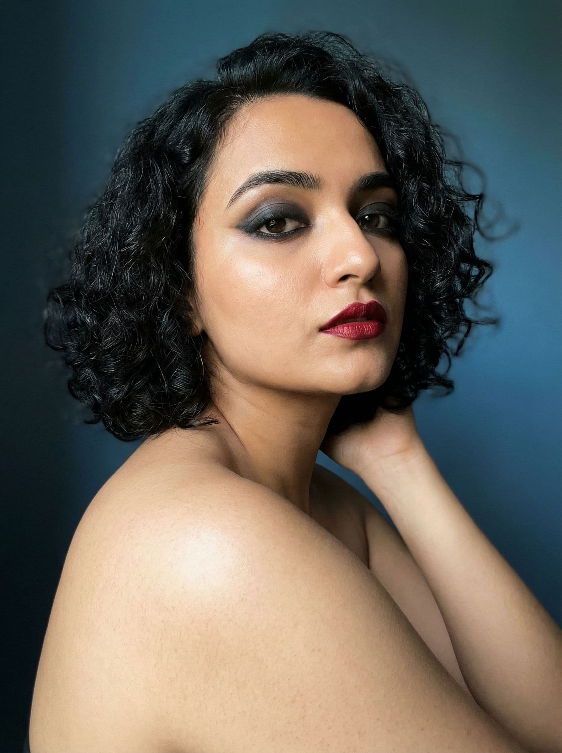 AI generated: Create a highly detailed, photorealistic portrait of a woman with short black hair and dramatic make...
