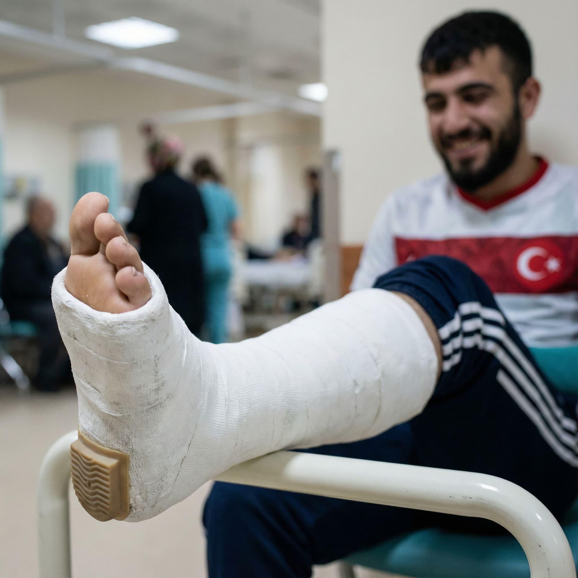 AI generated: Image of a thick leg cast in plaster with a small heel underneath the foot on a young turkish bearde...