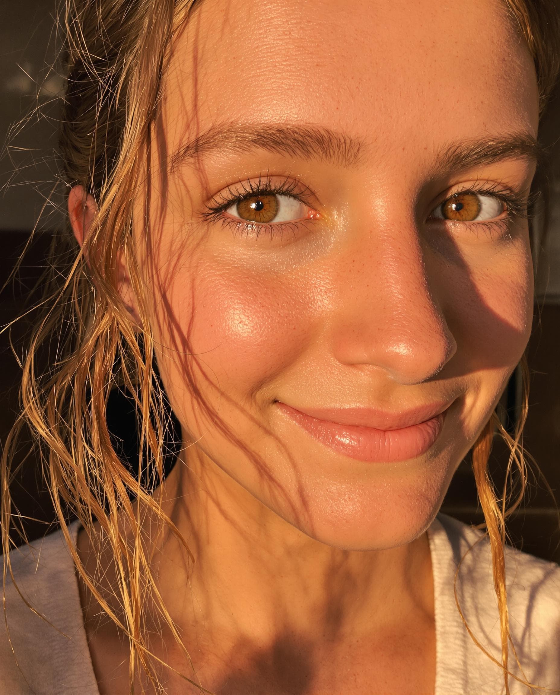 AI generated: low quality phone photo, snapchat, a close-up of a girl's face with warm brown eye's, wavy auburn ha...