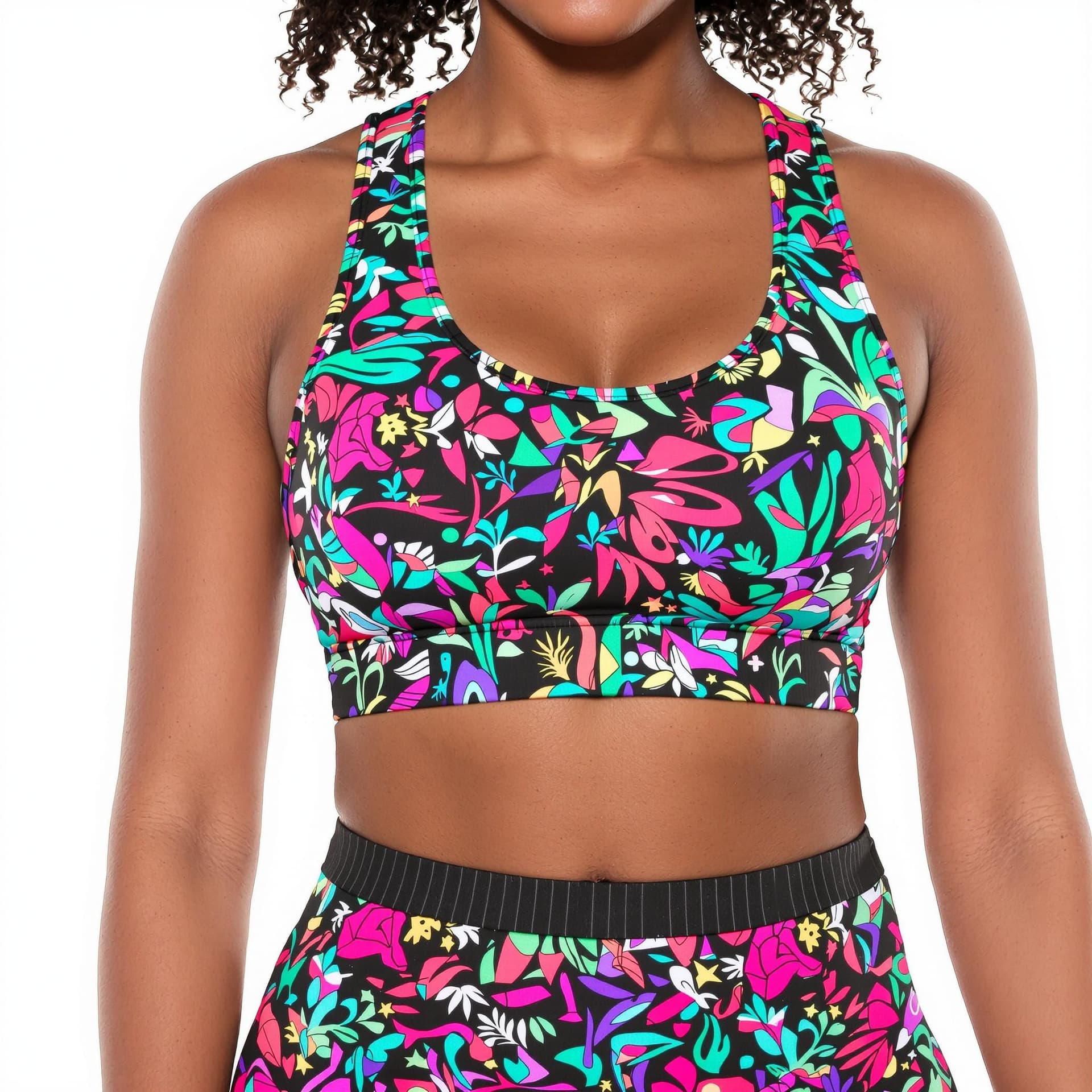 AI generated: a black woman wearing sports bra and matching leggings. The backdrop is white.