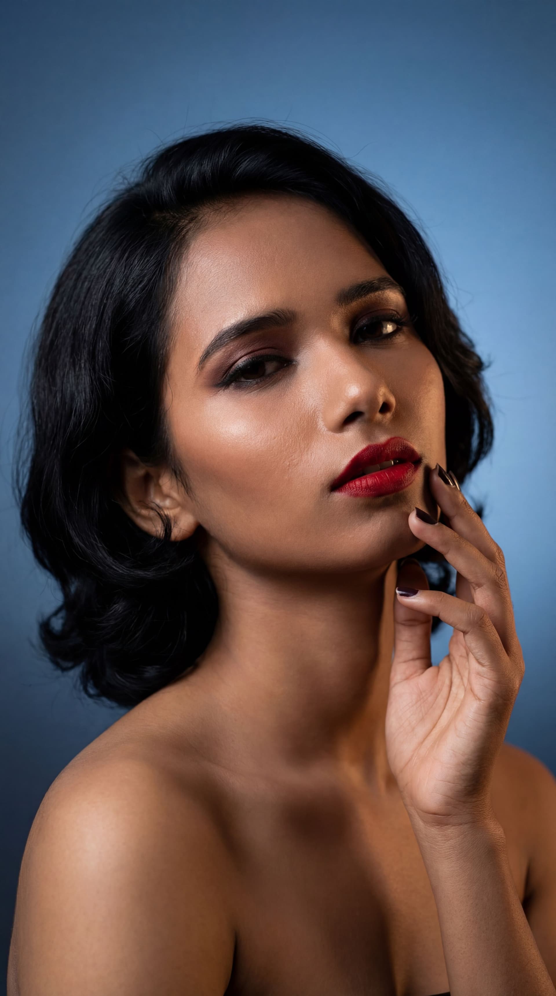 AI generated: Create a highly detailed, photorealistic portrait of a woman with short black hair and dramatic make...