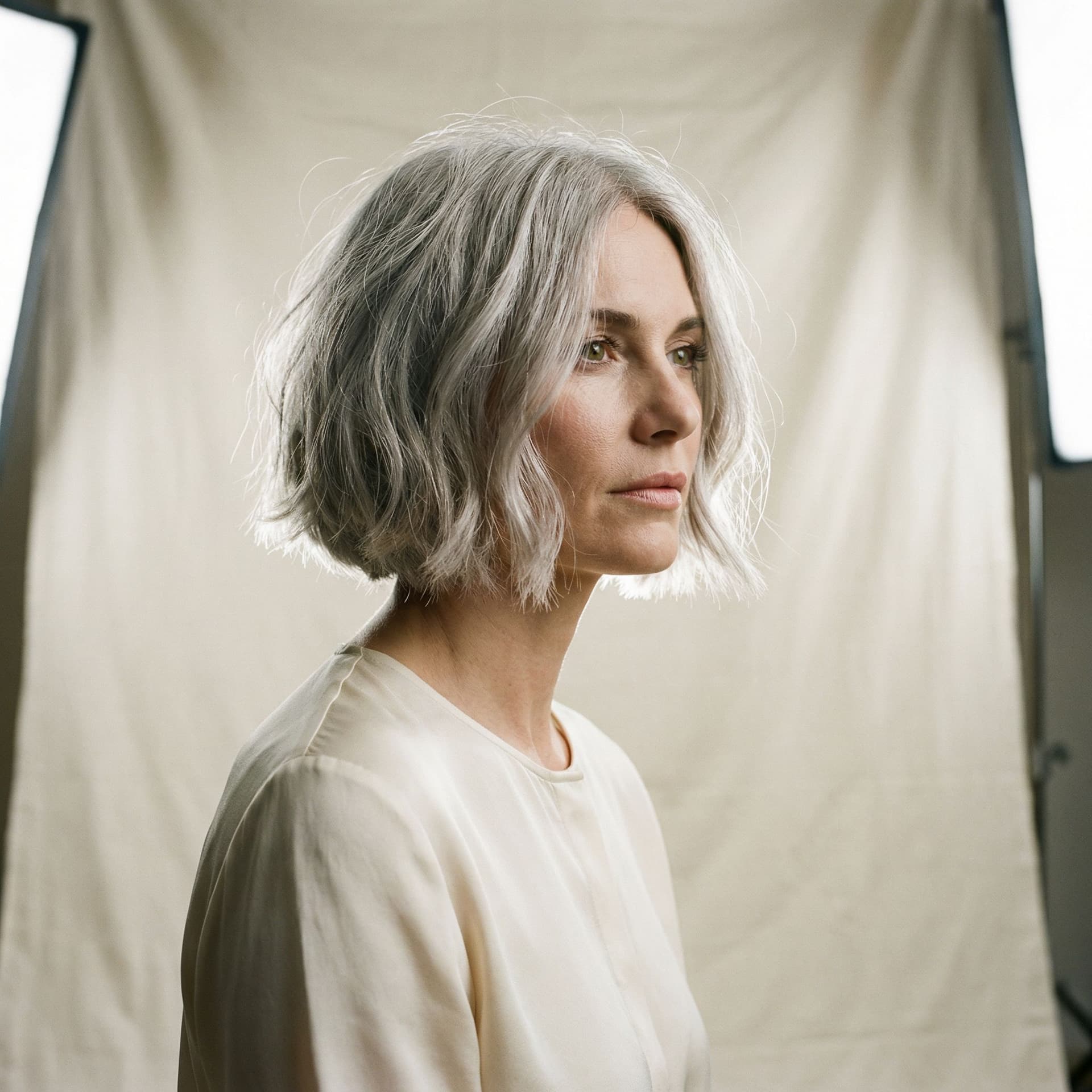 AI generated: hair photography, woman, bob cut hair, silver color, ivory hue background, studio lighting setup, re...
