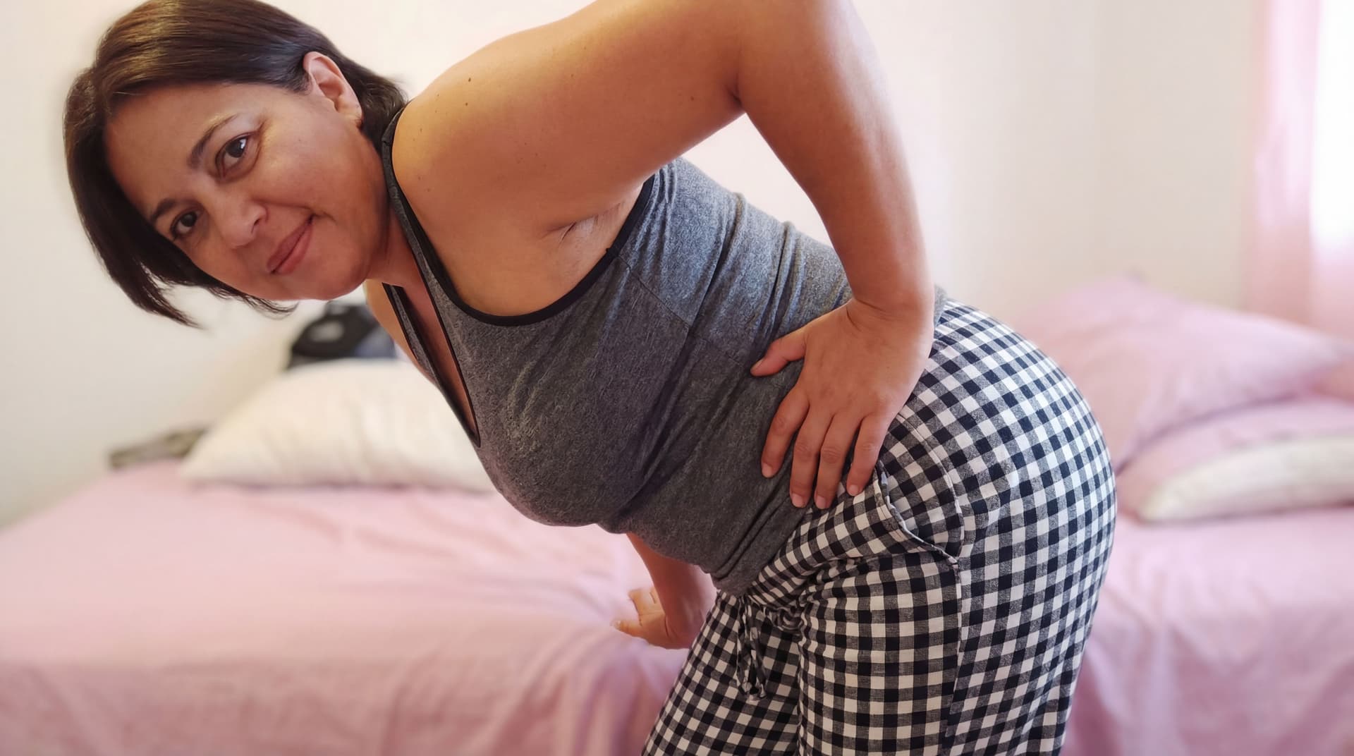 AI generated: the pesrson from the picture bend over spreading her ass with her own hand, and look backward