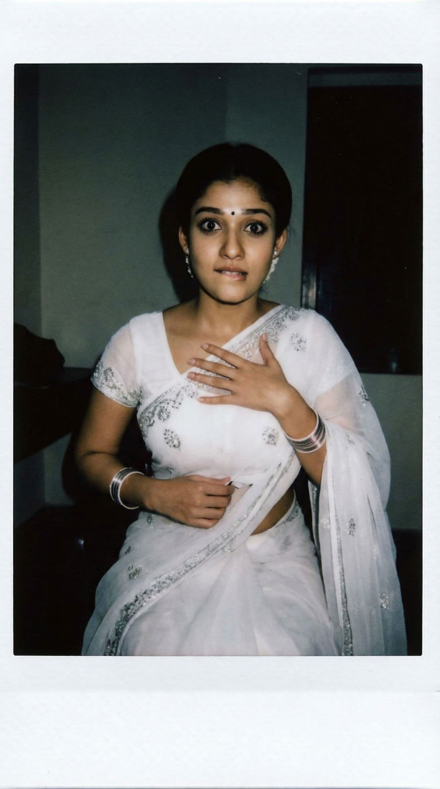 AI generated: nayanthara,  one hand on chest,biting her lip, 18-21 years old, brown hair, Indian hair style, saree...