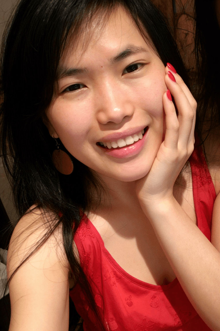 AI generated: 1girl, solo, Vietnamese girl, selfie, hand on cheek, smiling, grin, crimson red nails, candid amateu...
