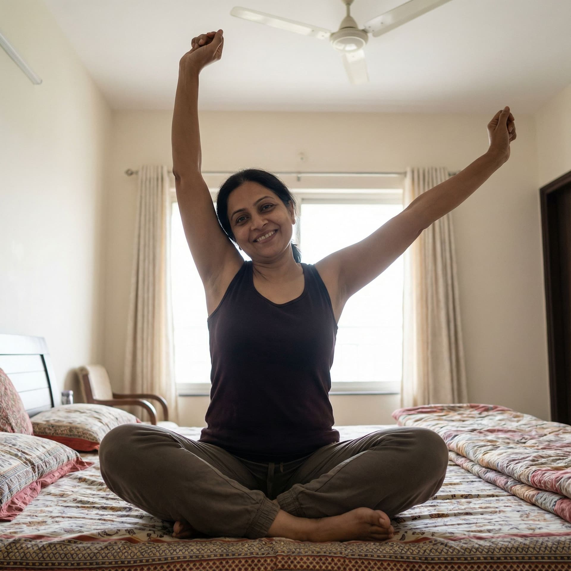 AI generated: Indian women with 45 years old age.She wears a deep sleeveless tank top raising hands.sitting on bed...