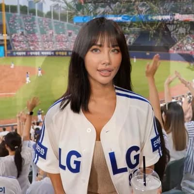 AI generated video: Create an ultra-realistic candid KBO baseball broadcast screenshot of the same woman accidentally ca...