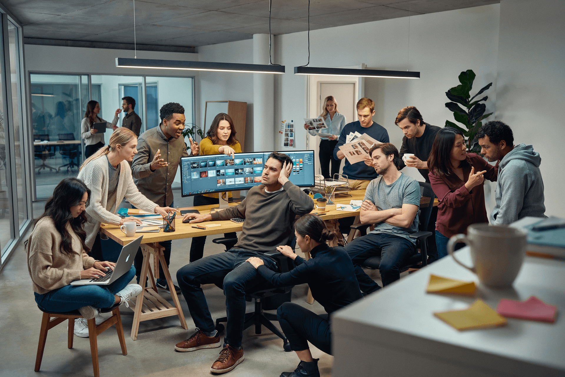 AI generated: A hyper-realistic modern creative agency office during a deadline. One experienced designer sits at ...