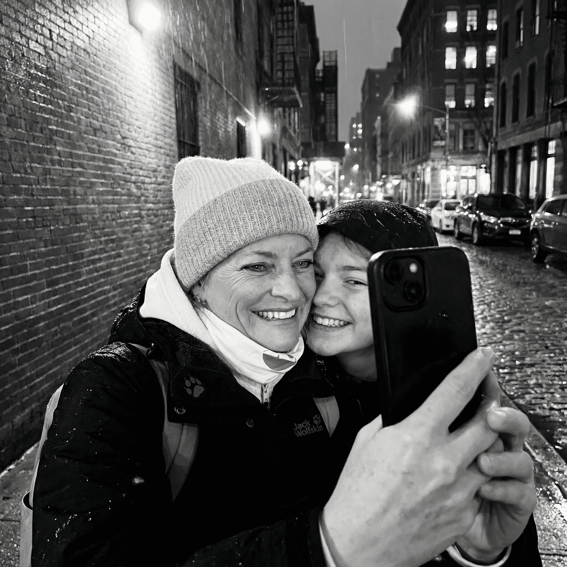 AI generated: black and white selfie in a dark and rainy new york backstreet 