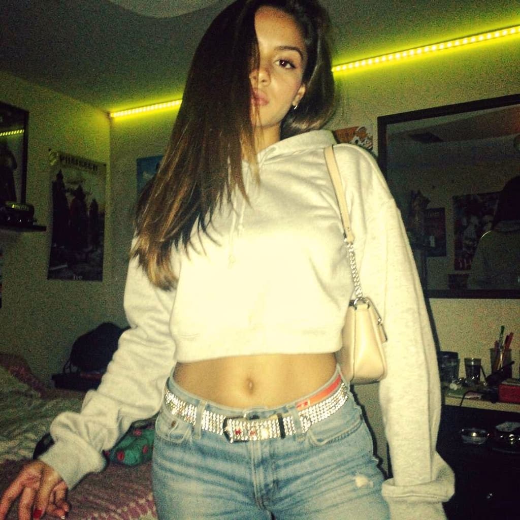 AI generated: a lo-fi 2015s-era, diagonally taken, low-quality iPhone photo of a 20-year-old baddie. The shot is i...