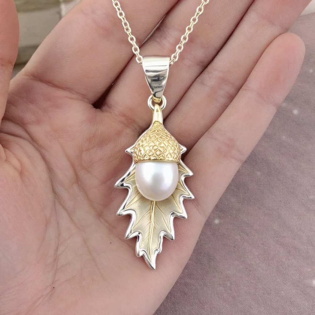 AI generated: an (oak leaf) and a pearl acorn pendant, made in silver and gold
