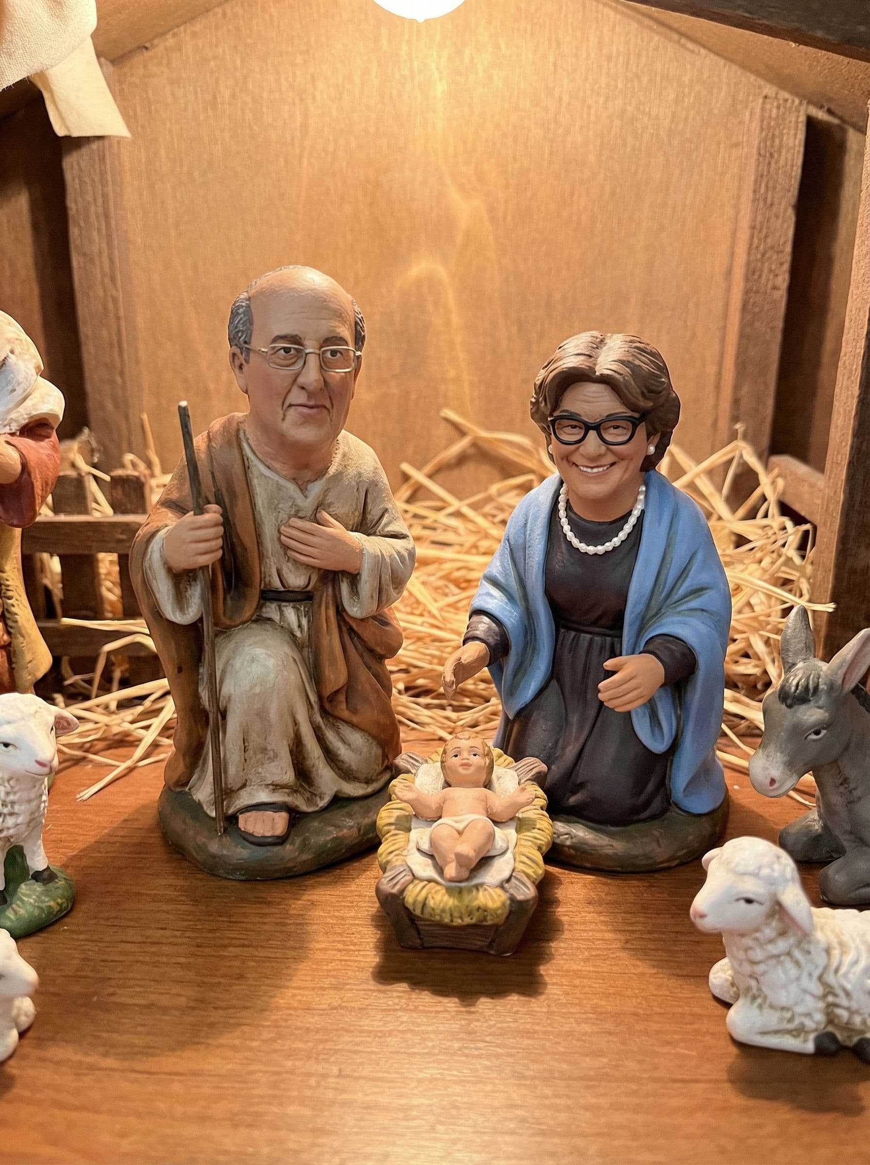 AI generated: take this couple and put like Jose in Maria in a nativity scene. they are figurines. keep the exact ...