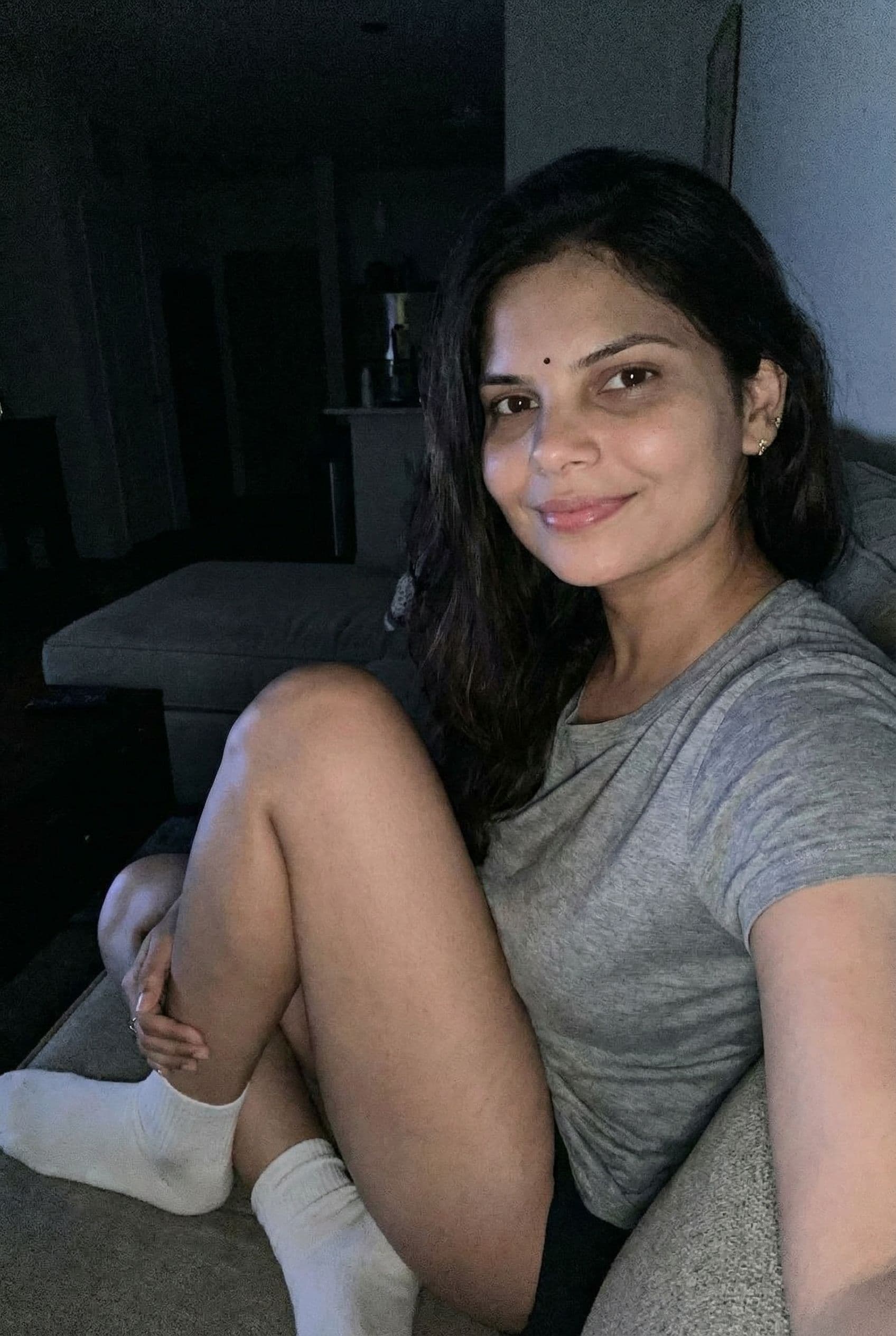 AI generated: Romantic iPhone full face selfie,a sloppy snapshot. sitting on a couch at night (no lights), wearing...