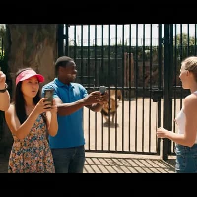 AI generated video: A group of tourists filming casually inside a zoo with their smartphones, walking near the lion encl...