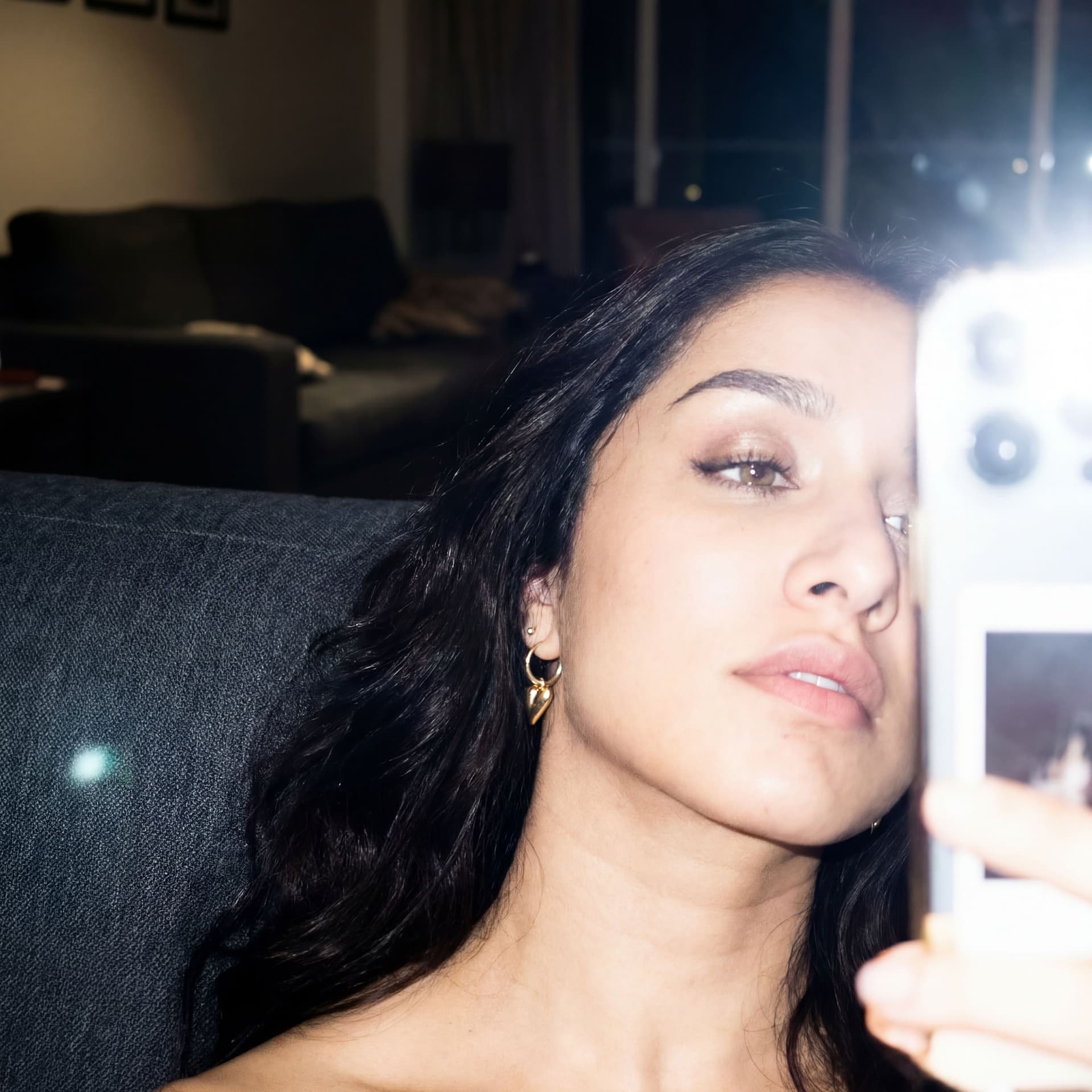AI generated: Using the uploaded reference photo, create a standard iPhone selfie with flash. There's no clear sub...