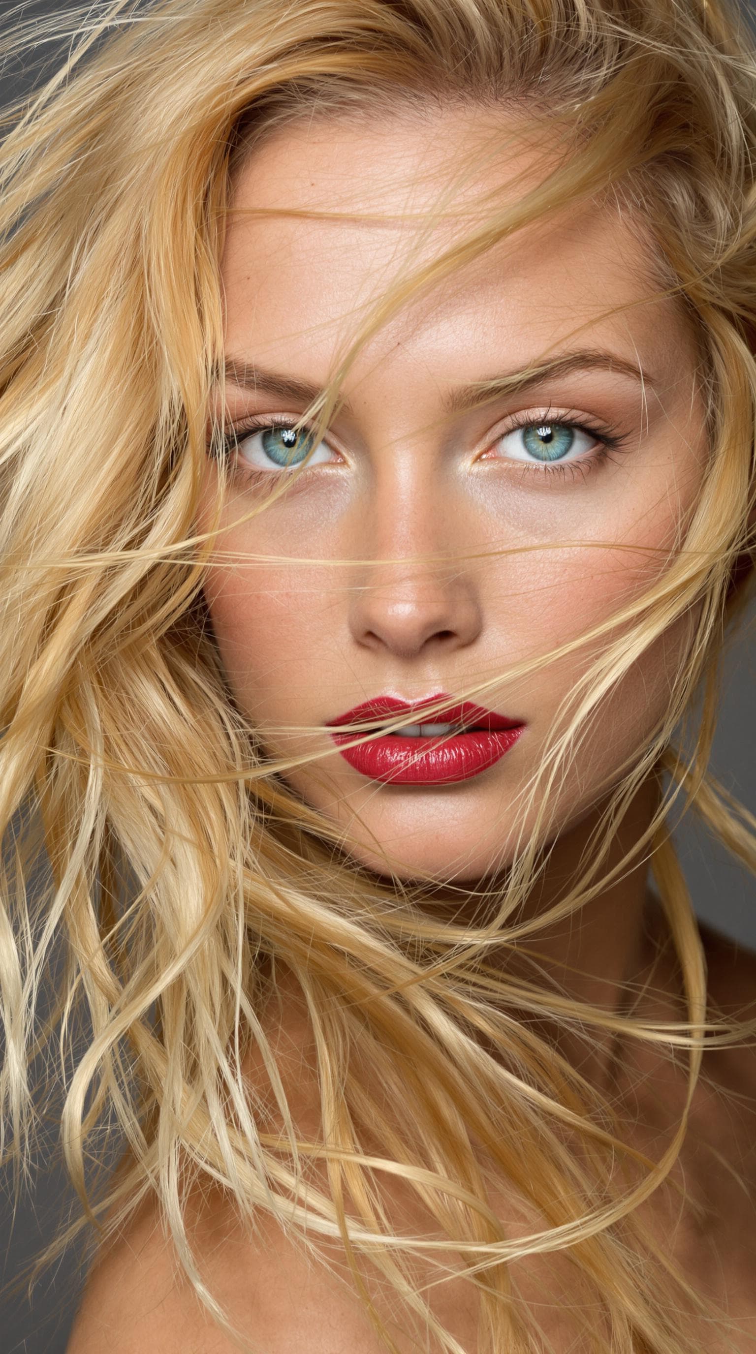 AI generated: "The image is a striking close-up portrait of a model with lustrous, tousled strawberry blonde hair ...