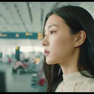 AI generated video: An ethereal, cinematic portrait of an impossibly beautiful woman seen fleetingly at an airport—a fac...
