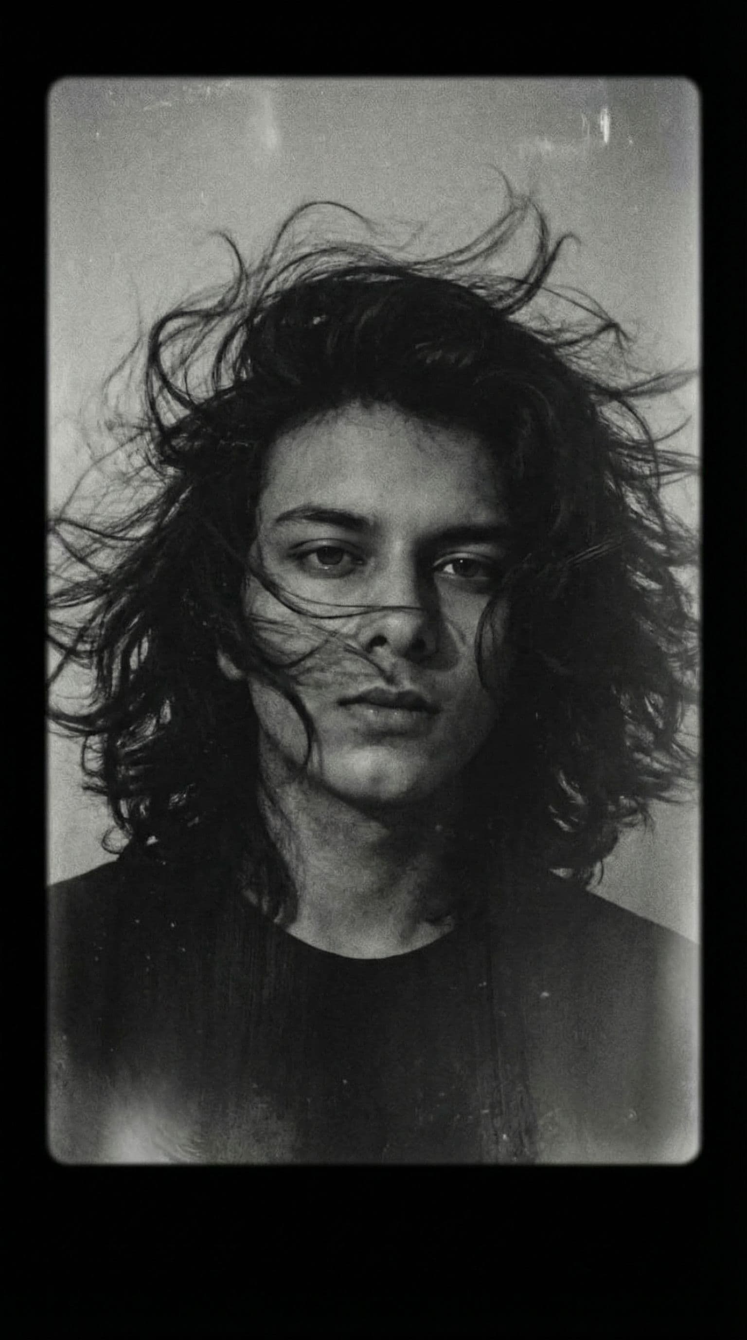 AI generated: a man with long wild hair on a windy day, in the style of toy camera effects, haunting elegance, fro...