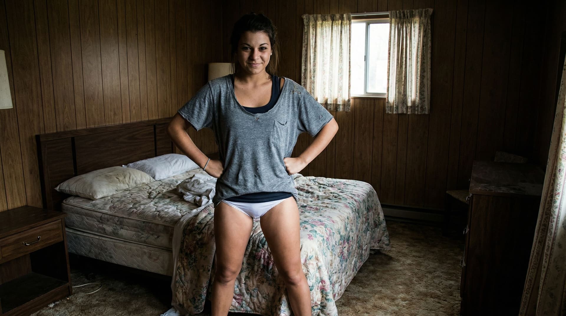 AI generated: In a very cheap looking motel room. One beautiful brunette girl with a tan and brown eyes is standin...