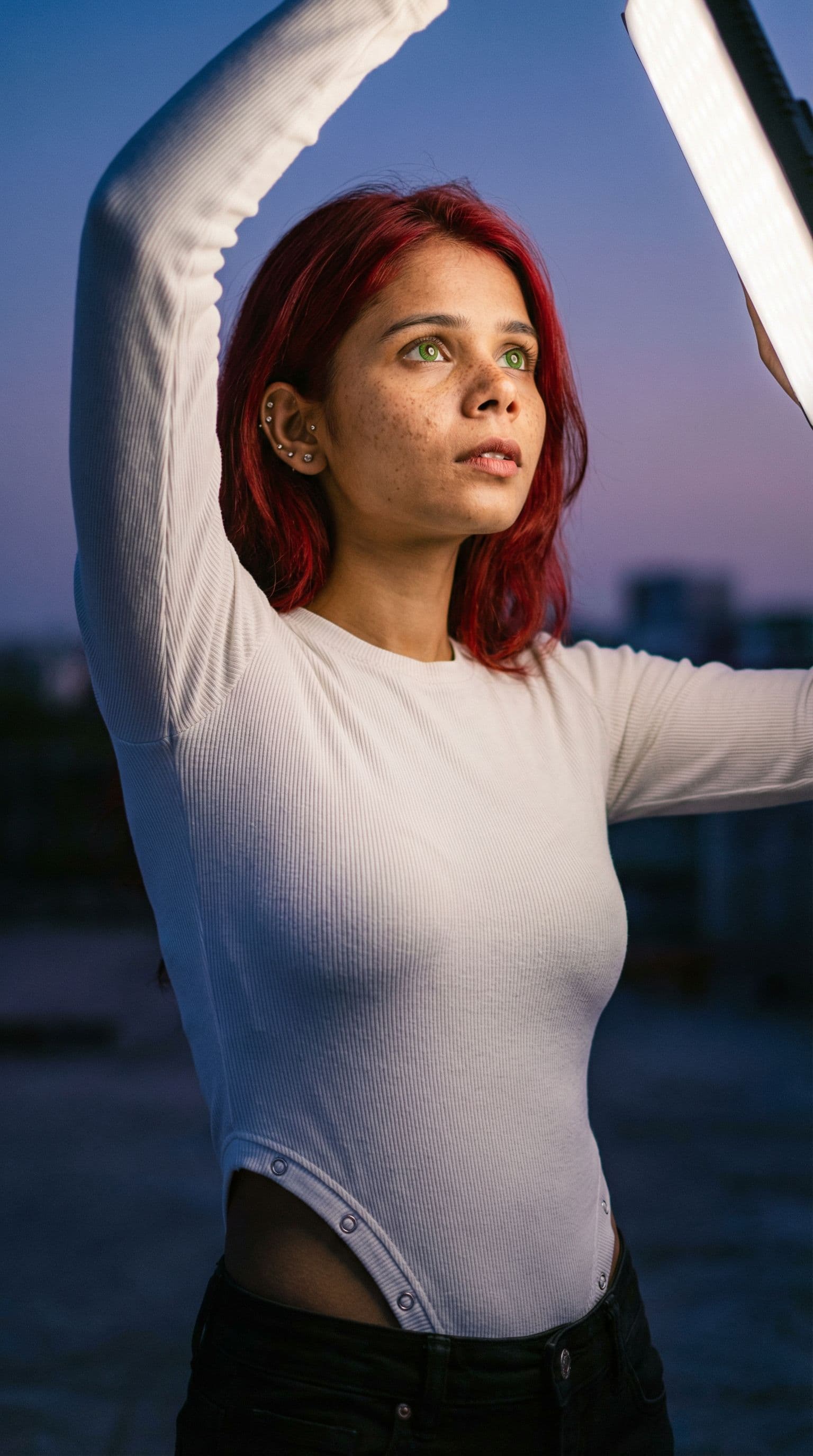 AI generated: Ultra-realistic twilight Head to toe shot of a red-haired woman with bright green eyes, freckles viv...