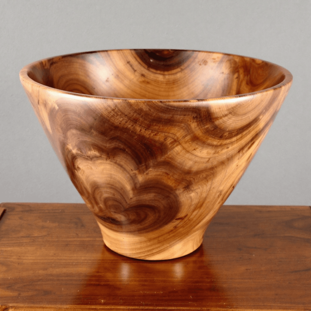 AI generated: SIDE PROFILE VIEW, A LARGE SMOOTH SIDED DEEP WOOD BOWL CARVED FROM WALNUT WOOD