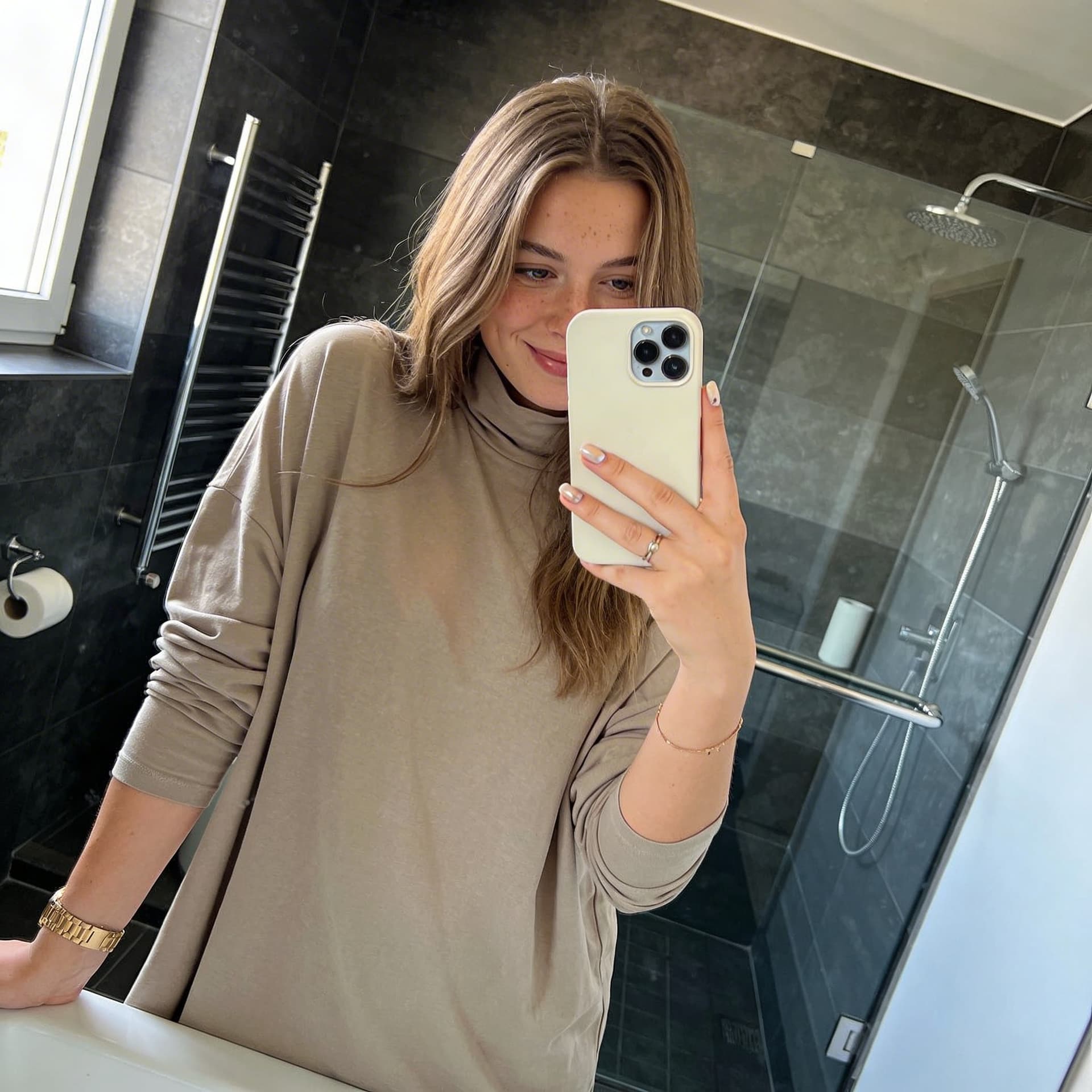 AI generated: Create an ultra-photorealistic horizontal (landscape) mirror selfie of a young adult woman (mid-20s)...