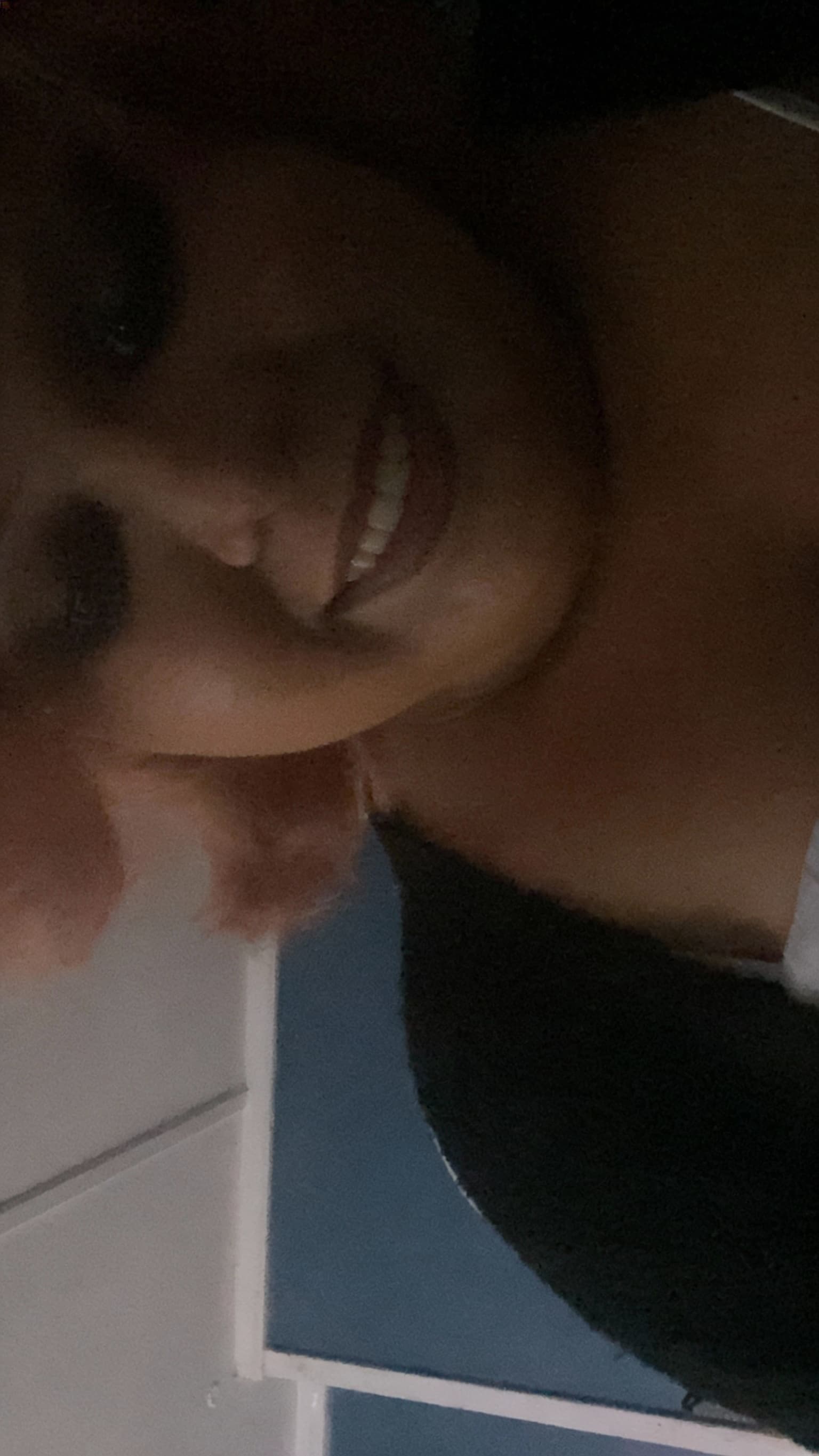 AI generated: Please use the image to show her smiling at the camers