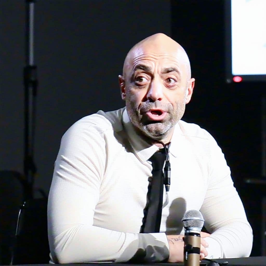 AI generated: Joe Rogan on a set with slenderman, miserable