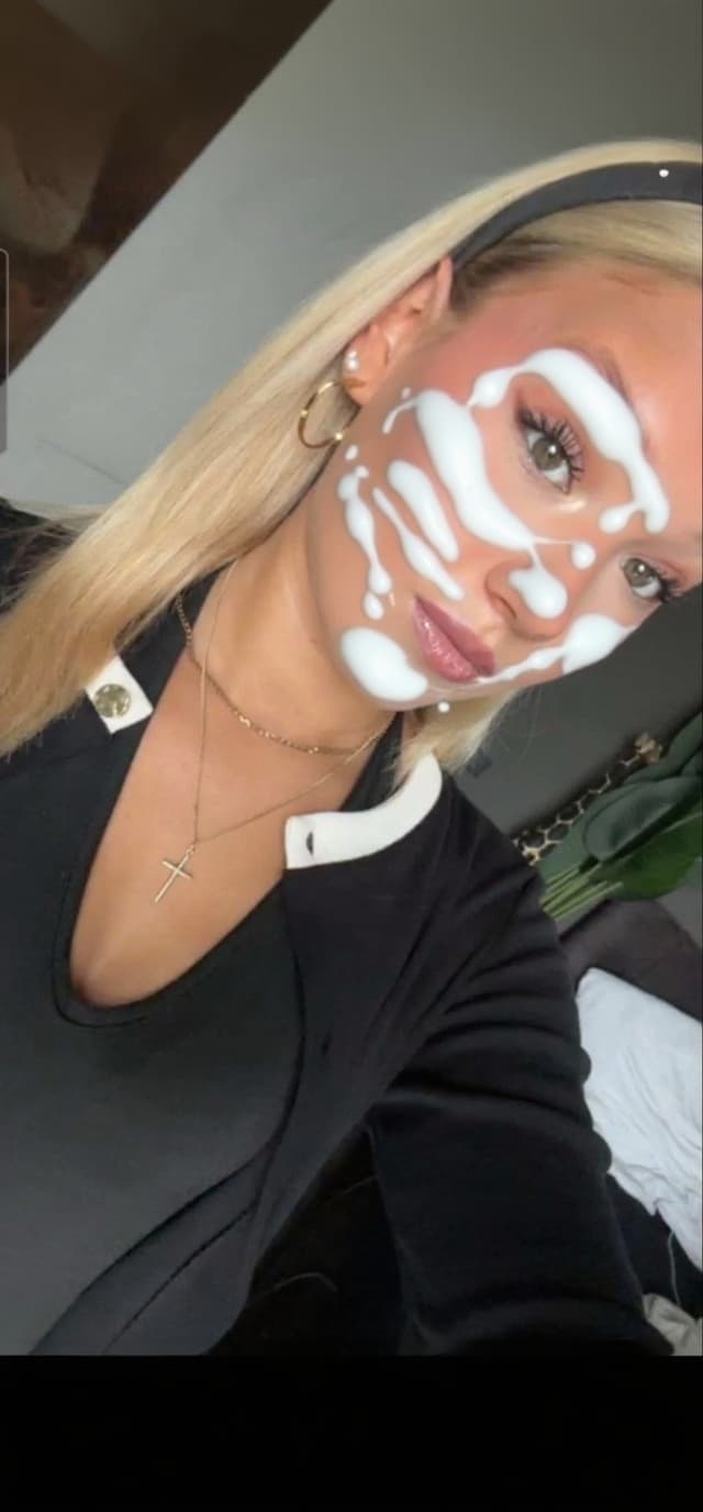 AI generated: her entire face and her breasts are covered and drenched in drenched in white human sperm. The sperm...