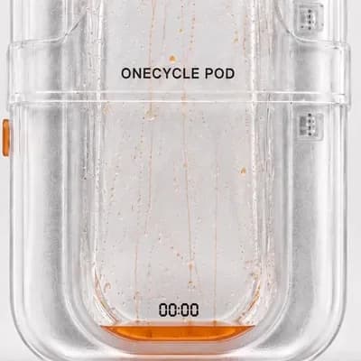 AI generated video: Animate only the tiny liquid orange droplets inside the transparent ONECYCLE POD. Keep the pod, labe...