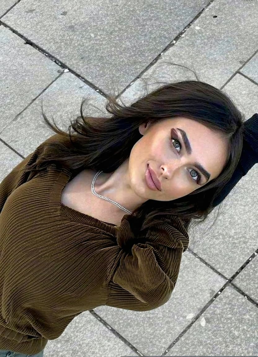 AI generated: Make the person from Image 1 take the exact pose and wear same clothing of the person in Image 2. 