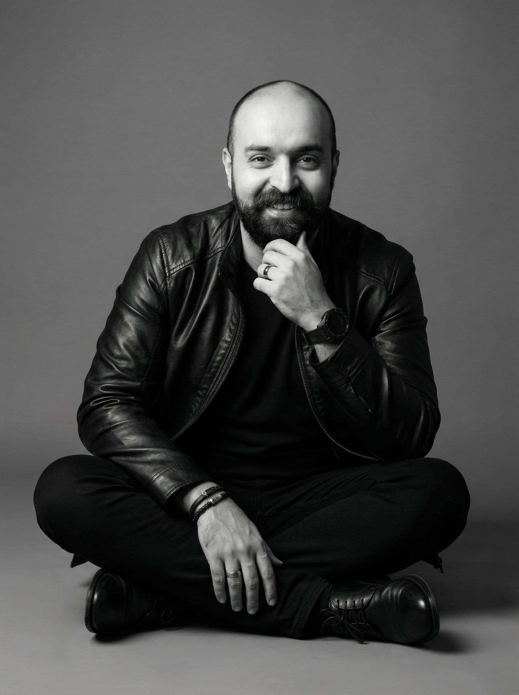AI generated: A black and white, full-length studio portrait capturing a male figure with a casual yet charismatic...