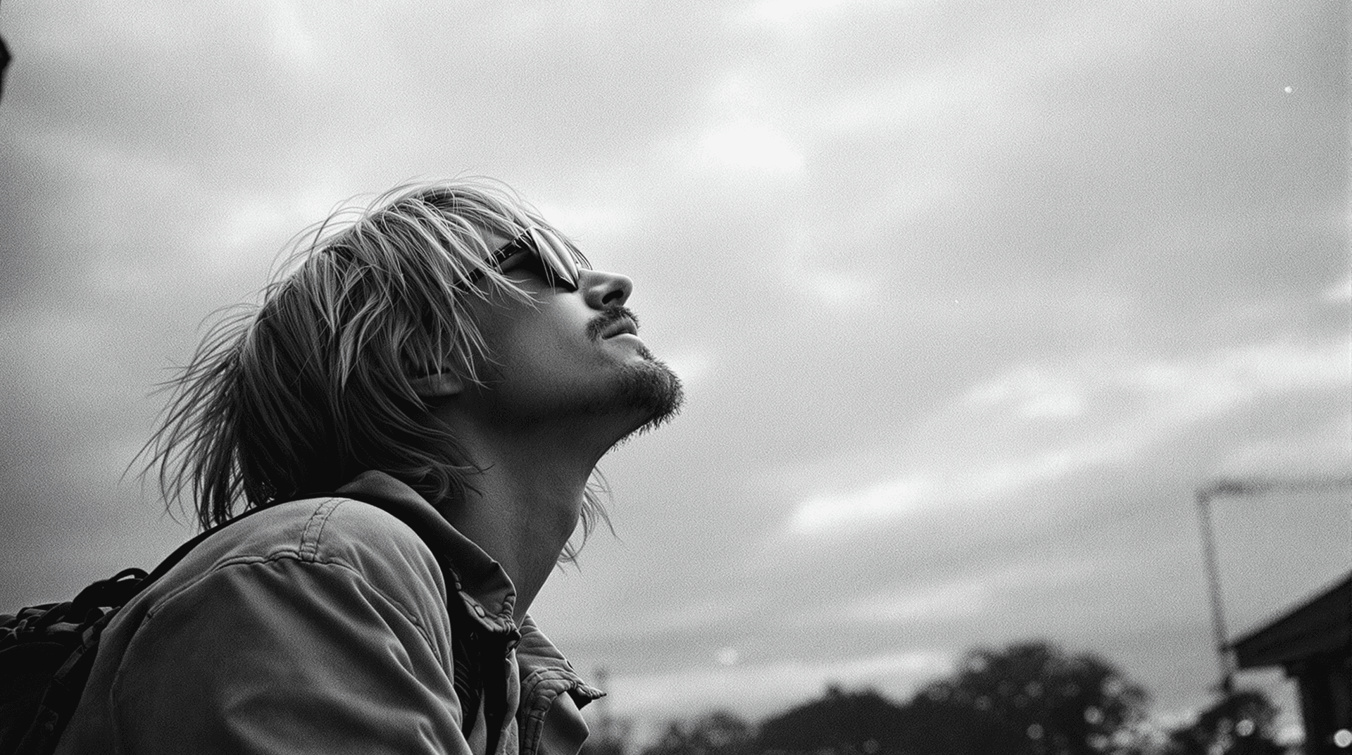 AI generated: rainy day,kurt cobain looking to the sky,travelling,depressive mood,monochrome tones,nikon 35 mm dsl...