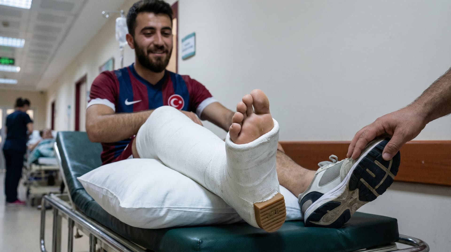 AI generated: Image of a thick leg cast in plaster with a small heel underneath the foot on a young turkish bearde...