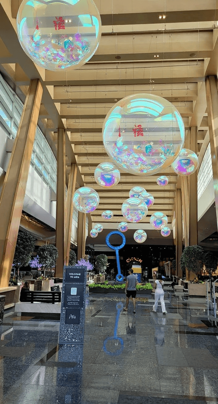 AI generated: carry-on luggage as a clear pvc balloon, stuffed with Japanese souvenirs. which floats as an exhibit...