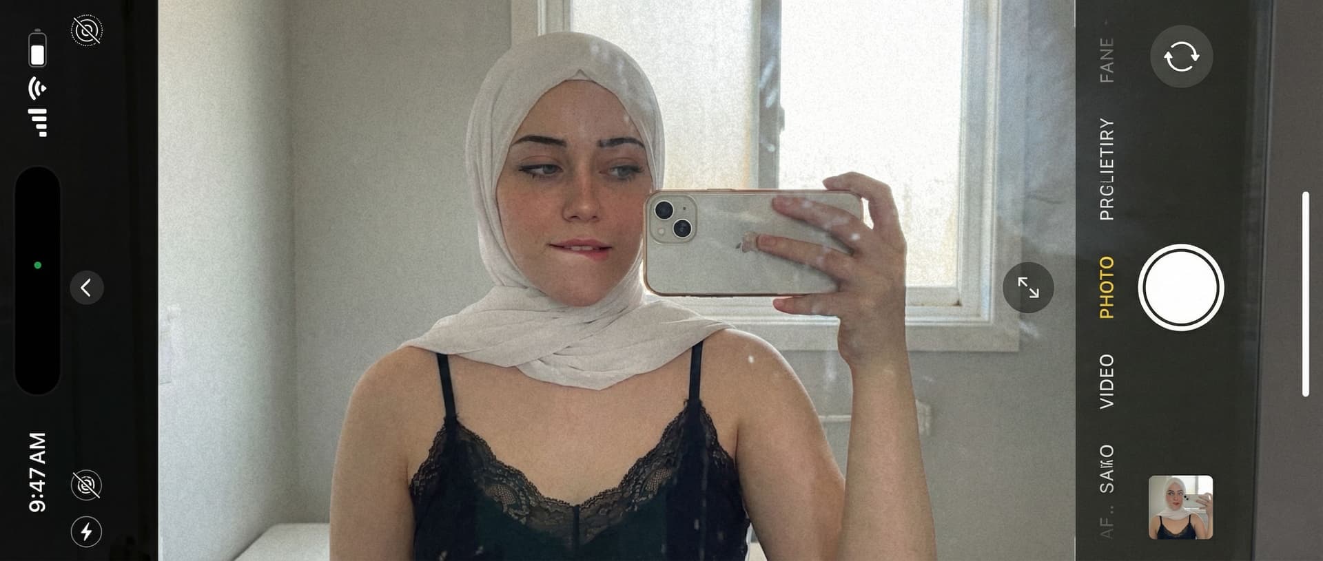 AI generated: Casual mirror selfie in a bathroom, smartphone photo quality. Slim brunette adult with a playful exp...
