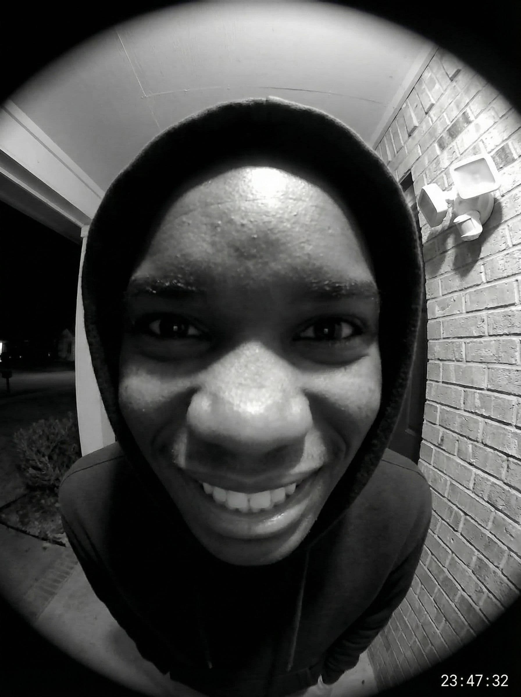 AI generated: Ultra-realistic doorbell camera POV, extreme fisheye distortion, face extremely close to the lens, e...