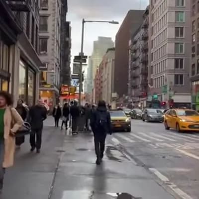 AI generated video: A realistic iPhone video recorded in first person, walking through a busy city full of people, cars,...