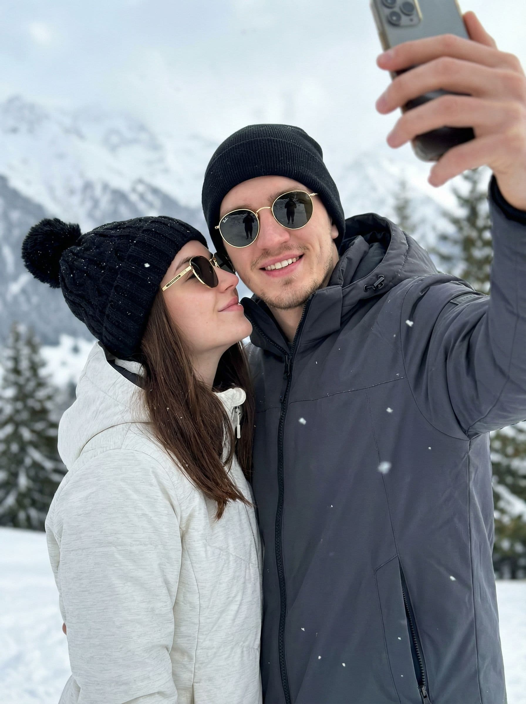 AI generated: 2-A high-quality, realistic winter selfie of a young couple standing very close together in a snowy ...