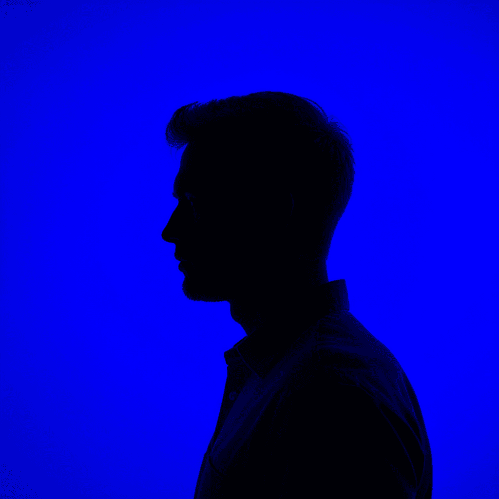 AI generated: photography, front, gaze, portrait, contrast, profile silhouette of a man against a vibrant deep blu...