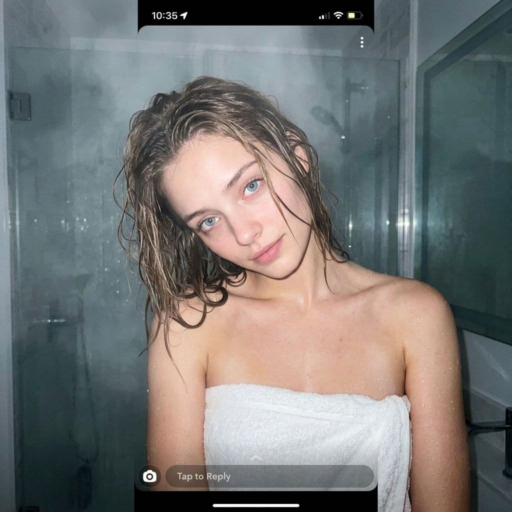 AI generated: low quality phone photo, snapchat, front shot, upper body, 25 year old girl, in the bathroom, just o...