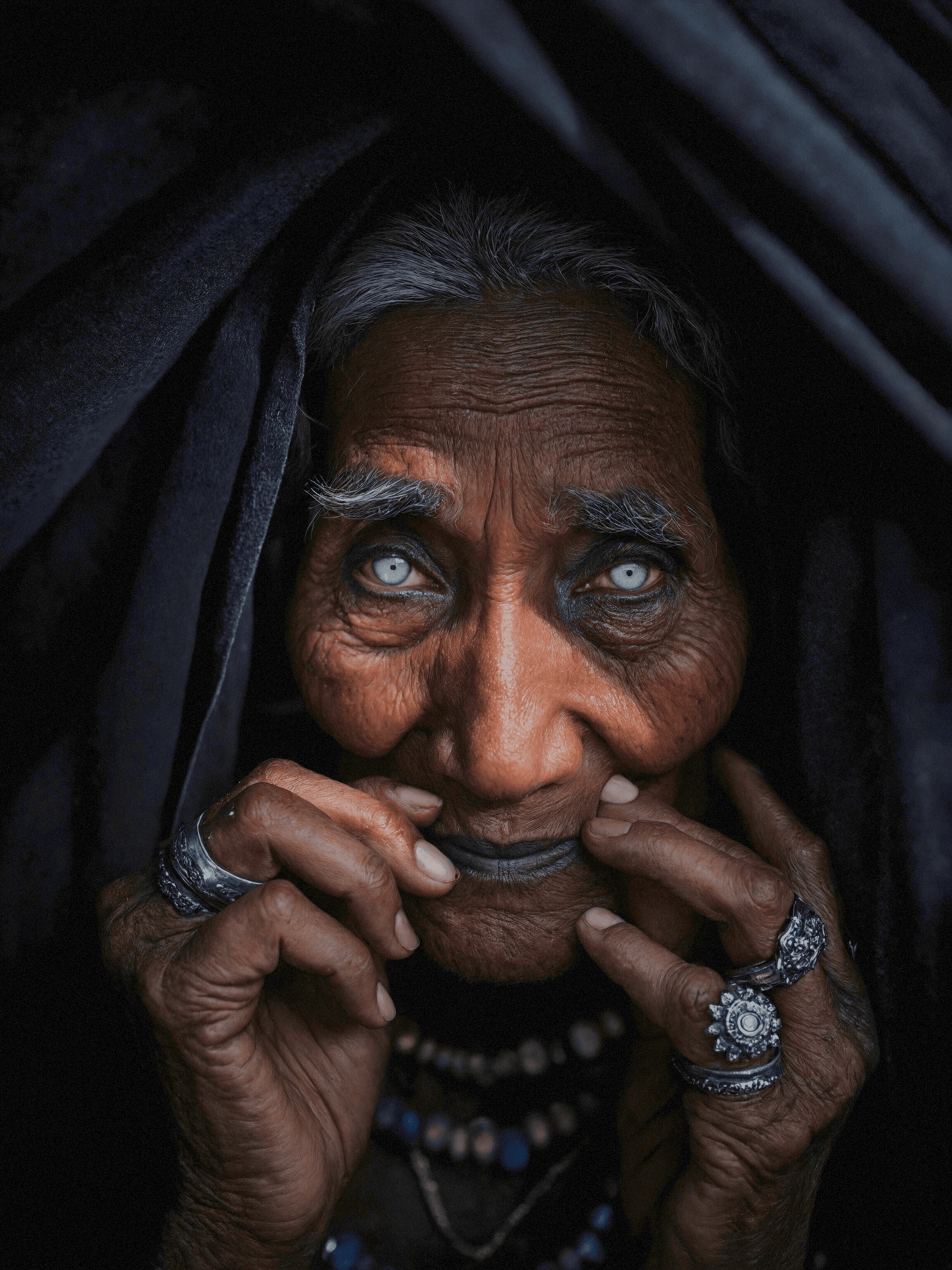 AI generated: Ultra-detailed RAW portrait of an elderly tribal woman with intense pale eyes, photographed extremel...