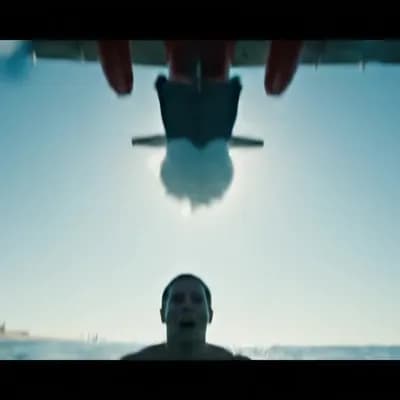 AI generated video: [POV SHOT], [HANDHELD + WATER DROPLETS ON LENS], [sunny beach coastline, swimmer treading water calm...